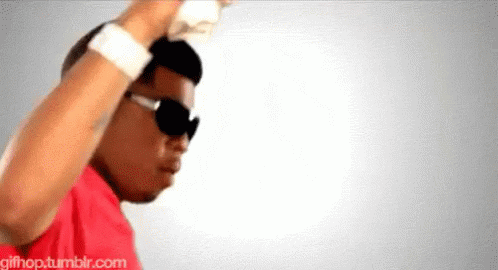 A Man Wearing Sunglasses And A Red Shirt Is Dancing In Front Of A White Background .. GIF