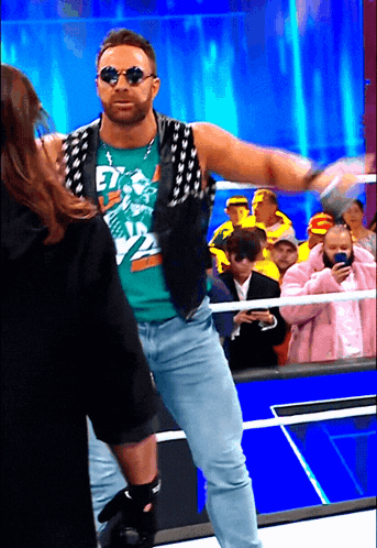 A Man Wearing Sunglasses And A Shirt That Says " Et " On It GIF
