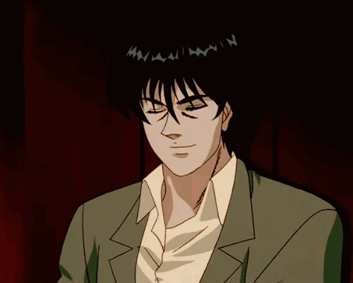 A Man Wearing Sunglasses And A Suit Is Looking At Something GIF