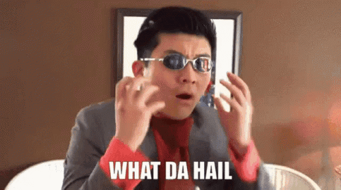 A Man Wearing Sunglasses And A Suit Is Making A Funny Face And Says What Da Hail . GIF