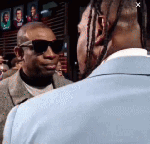 A Man Wearing Sunglasses And A Suit Talks To Another Man GIF