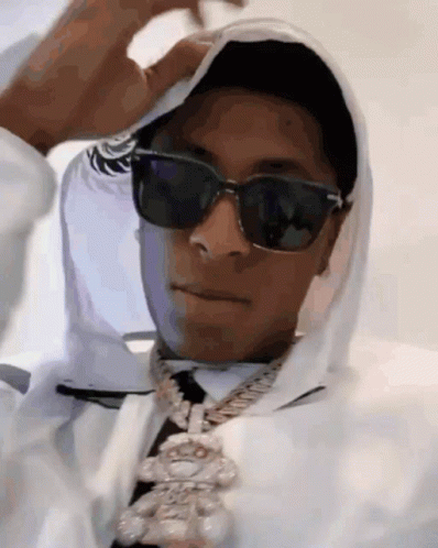 A Man Wearing Sunglasses And A White Hoodie Is Covering His Face . GIF