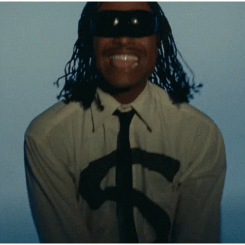 A Man Wearing Sunglasses And A White Shirt With A Dollar Sign On It GIF