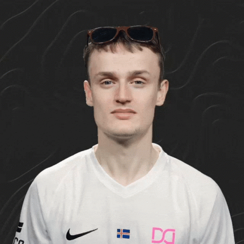A Man Wearing Sunglasses And A White Shirt With The Letter Dg On It GIF