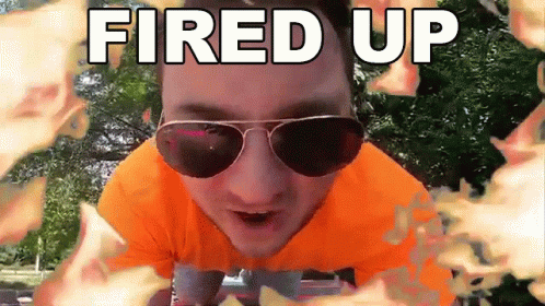 A Man Wearing Sunglasses And An Orange Shirt With The Words Fired Up Behind Him GIF