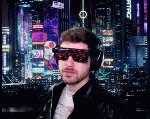A Man Wearing Sunglasses And Headphones Stands In Front Of A City Skyline With A Sign That Says Attac GIF