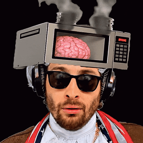 A Man Wearing Sunglasses And Headphones With A Microwave On His Head That Says Brains GIF