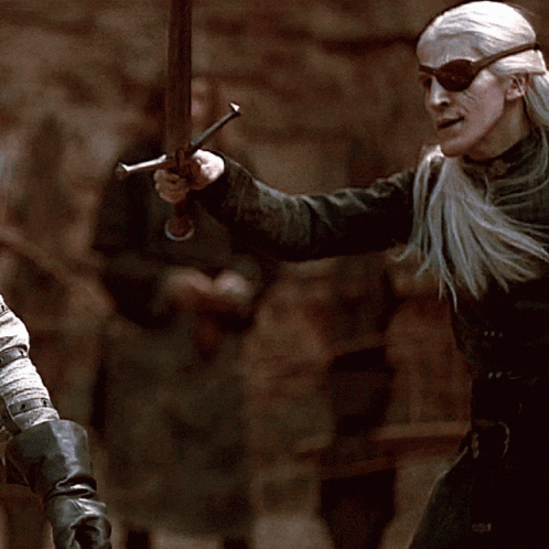 A Man Wearing Sunglasses And Holding A Sword In His Hand GIF