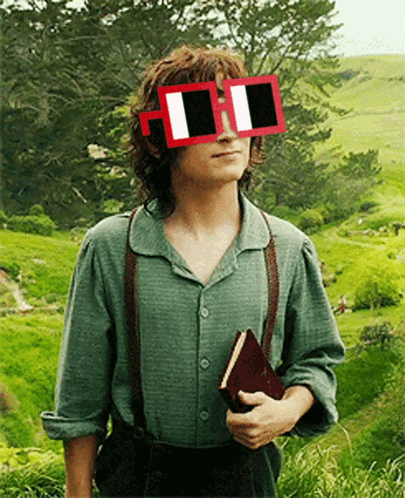 A Man Wearing Sunglasses And Suspenders Holds A Book In His Hand GIF