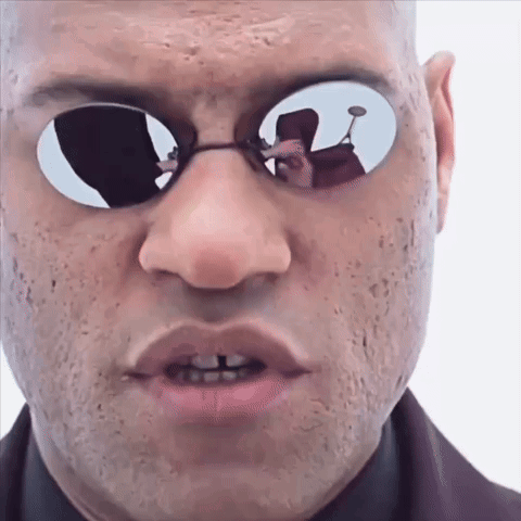 A Man Wearing Sunglasses Has A Reflection Of Another Man In His Glasses GIF