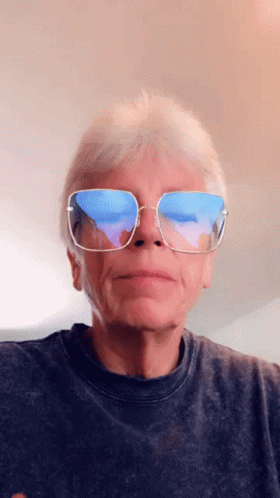 A Man Wearing Sunglasses Has A Reflection Of The Ocean In His Lenses GIF