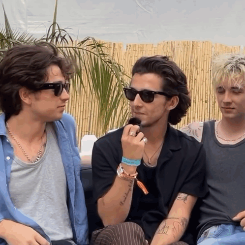 A Man Wearing Sunglasses Has A Tattoo On His Arm That Says " I 'M A Bitch " GIF