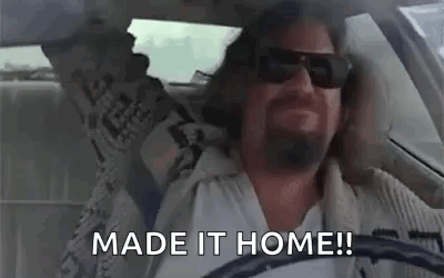 A Man Wearing Sunglasses Is Driving A Car And Says `` Made It Home ! '' GIF