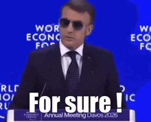 A Man Wearing Sunglasses Is Giving A Speech At The World Economic Forum Annual Meeting GIF