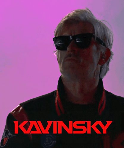 A Man Wearing Sunglasses Is Giving The Middle Finger In Front Of A Kavinsky Logo GIF