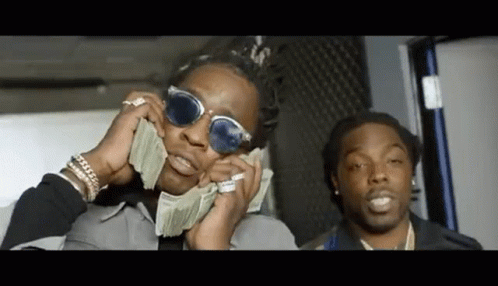 A Man Wearing Sunglasses Is Holding A Bunch Of Money In His Hands . GIF