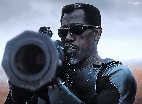 A Man Wearing Sunglasses Is Holding A Gun And The Word Kepler Is On The Bottom Right GIF