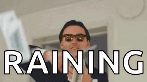 A Man Wearing Sunglasses Is Holding A Piece Of Paper With The Word Raining Written On It . GIF
