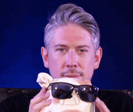 A Man Wearing Sunglasses Is Holding A Skull In His Hands GIF