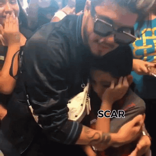 A Man Wearing Sunglasses Is Hugging A Little Boy With The Word Scar Written On The Bottom GIF