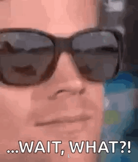 a man wearing sunglasses is making a funny face .