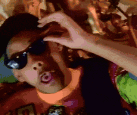A Man Wearing Sunglasses Is Making A Heart Shape With His Hands GIF