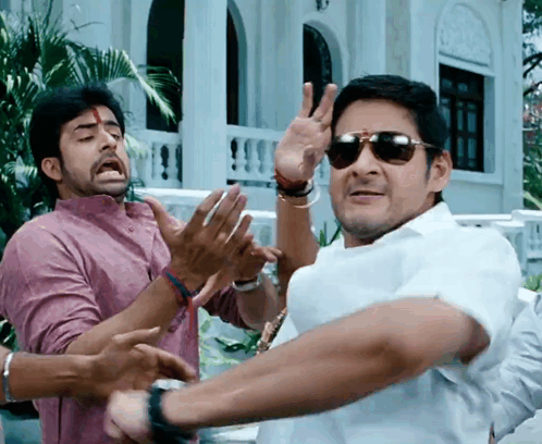 A Man Wearing Sunglasses Is Making A Peace Sign With His Hands GIF