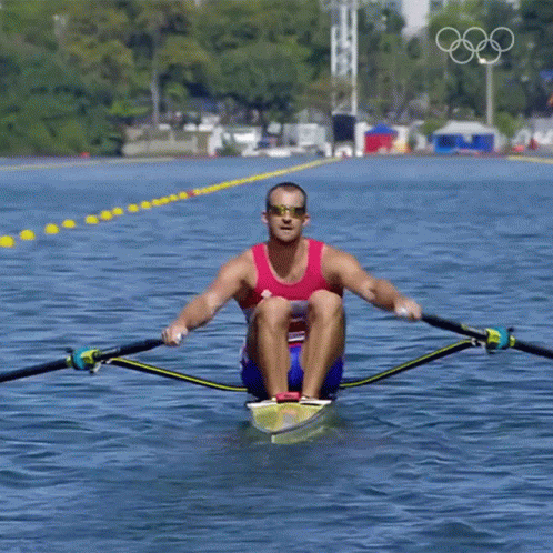 A Man Wearing Sunglasses Is Rowing A Boat In The Water GIF