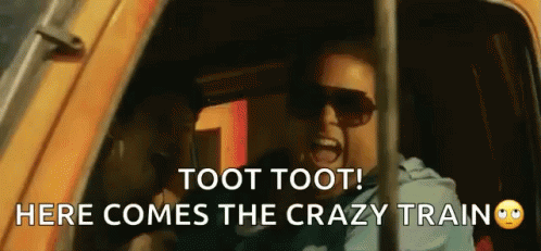 A Man Wearing Sunglasses Is Screaming In A Car With The Words Toot Toot Here Comes The Crazy Train GIF