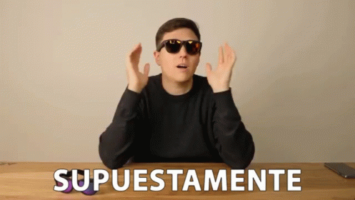 A Man Wearing Sunglasses Is Sitting At A Table With The Word Supuestamente Written On The Table GIF