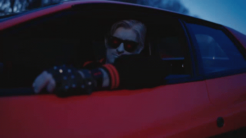 A Man Wearing Sunglasses Is Sitting In A Car GIF