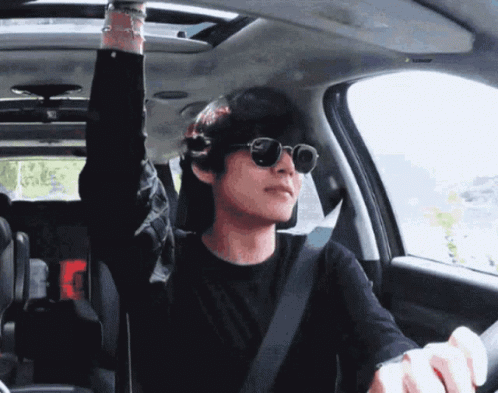 A Man Wearing Sunglasses Is Sitting In A Car GIF