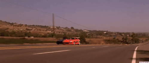 A Man Wearing Sunglasses Is Sitting In A Car With A Can Of Soda In His Hand GIF