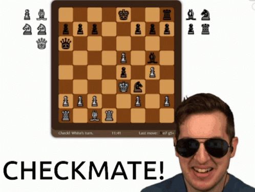 A Man Wearing Sunglasses Is Smiling In Front Of A Chess Board That Says Checkmate On It GIF
