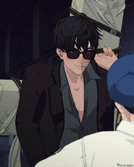 A Man Wearing Sunglasses Is Smoking A Cigarette While Another Man Watches GIF