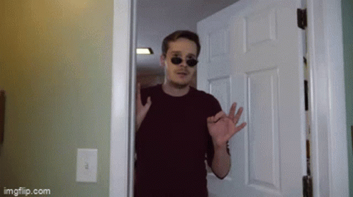 A Man Wearing Sunglasses Is Standing In A Doorway With Imgflip.com Written On The Bottom GIF