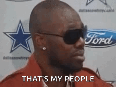 A Man Wearing Sunglasses Is Standing In Front Of A Ford Logo And Says `` That 'S My People '' . GIF