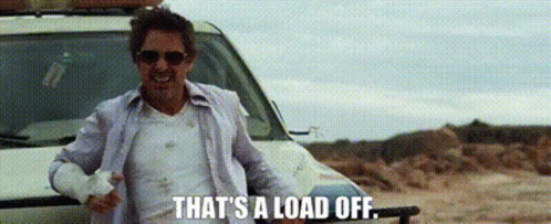 A Man Wearing Sunglasses Is Standing Next To A Car And Says `` That 'S A Load Off '' . GIF