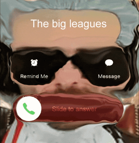 A Man Wearing Sunglasses Is Talking On A Phone With The Big Leagues Written Above Him GIF