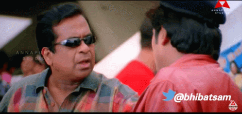 A Man Wearing Sunglasses Is Talking To Another Man With The Twitter Username @Bhibatsam GIF