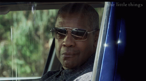 A Man Wearing Sunglasses Looks Out Of A Blue Car Window With The Words The Little Things Below Him GIF