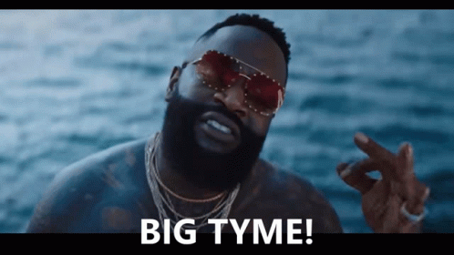 A Man Wearing Sunglasses Says " Big Tyme " In Front Of The Ocean GIF