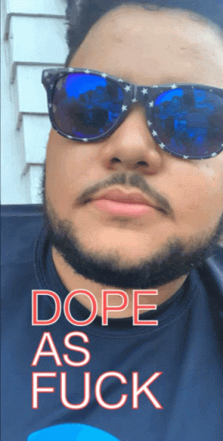 A Man Wearing Sunglasses Says Dope As Fuck On His Shirt GIF