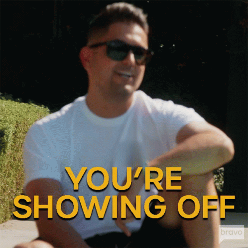 A Man Wearing Sunglasses Says You 'Re Showing Off In Yellow Letters GIF