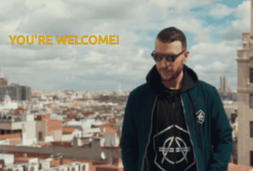 A Man Wearing Sunglasses Stands In Front Of A City With The Words " You 'Re Welcome " Below Him GIF