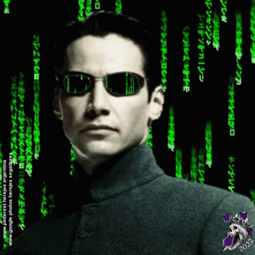 A Man Wearing Sunglasses Stands In Front Of A Green Background That Says ' Matrix ' On It GIF