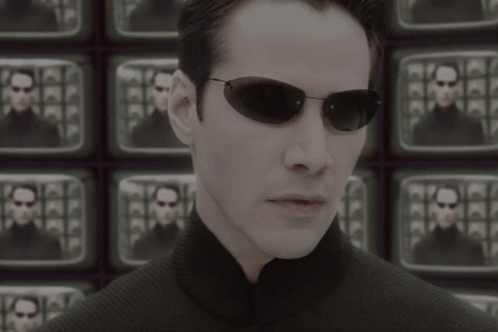 A Man Wearing Sunglasses Stands In Front Of A Wall Of Televisions With The Words The Problem Is Choice Below Him GIF