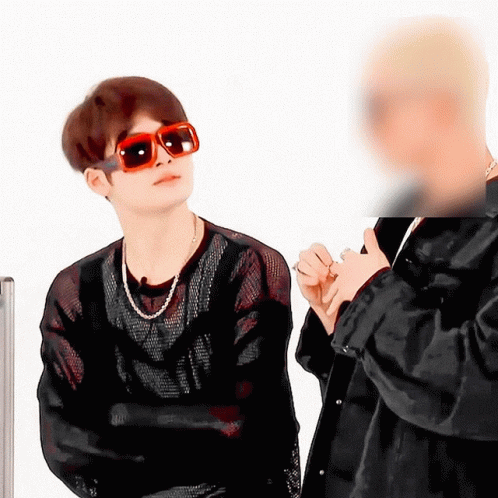 A Man Wearing Sunglasses Stands Next To Another Man In A Black Jacket GIF