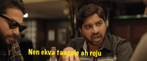 a man wearing sunglasses talks to another man with the words " nen ekva taagale ah roju " behind him