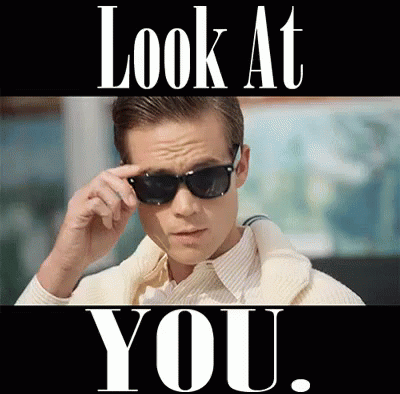A Man Wearing Sunglasses With The Words Look At You Behind Him GIF